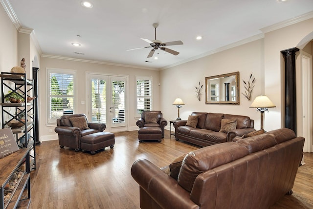 living room featuring ornamental molding, hardwood / wood-style floors, ornate columns, and ceiling fan