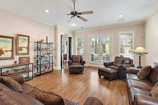 living room with crown molding, hardwood / wood-style floors, and ceiling fan