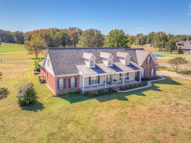 new england style home featuring a front lawn