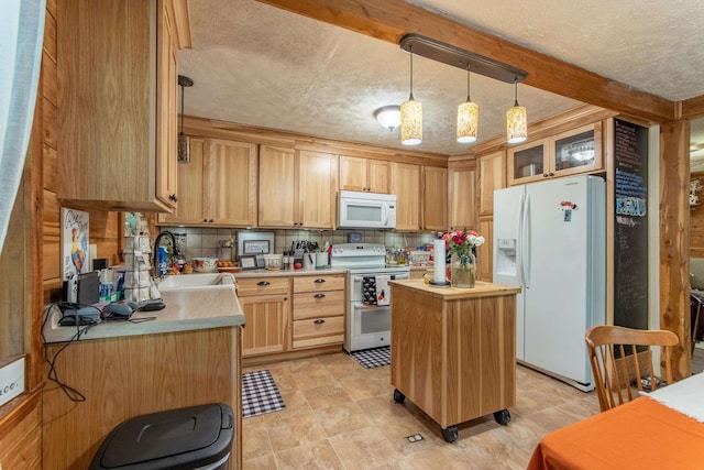 kitchen with white appliances, a textured ceiling, a center island, and sink