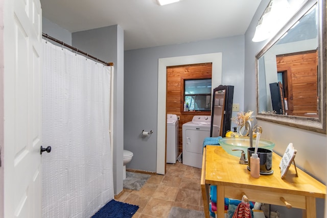 bathroom with vanity, toilet, and washing machine and clothes dryer