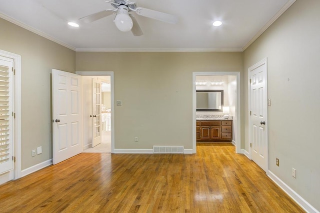 unfurnished bedroom with connected bathroom, crown molding, light wood-type flooring, and ceiling fan