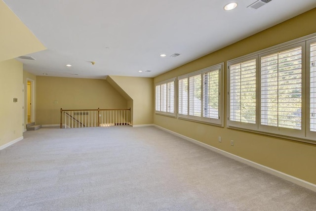 bonus room featuring light colored carpet