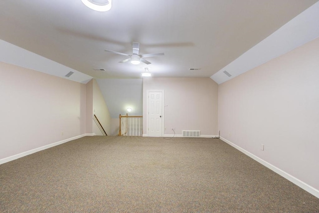 carpeted empty room featuring lofted ceiling and ceiling fan