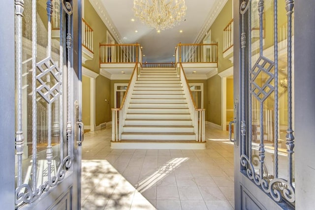 tiled foyer with crown molding, french doors, and a notable chandelier