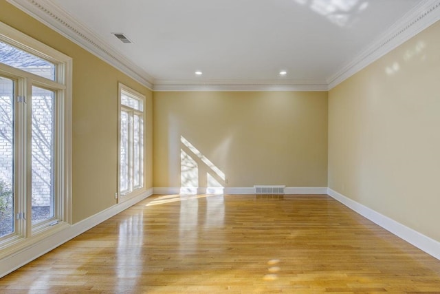 unfurnished room featuring light hardwood / wood-style floors and ornamental molding