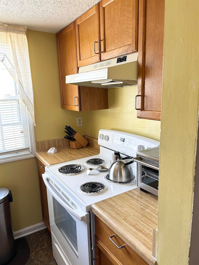 kitchen featuring electric range and a textured ceiling