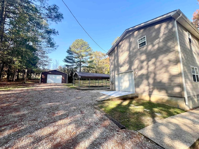 view of property exterior with a garage and an outbuilding