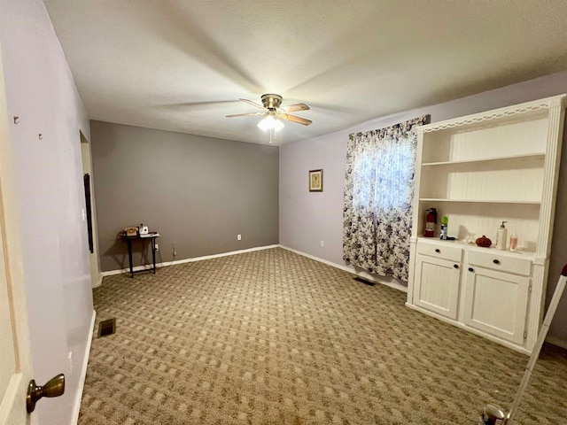 spare room featuring light colored carpet and ceiling fan