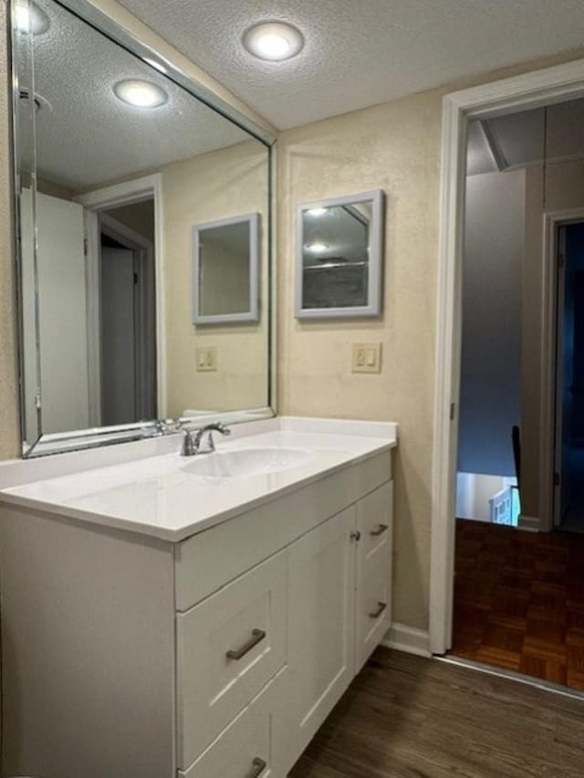 1231 Chamberlain Dr Unit 1231, Memphis, TN 38119 - bathroom featuring vanity, a textured ceiling, baseboards, and wood finished floors