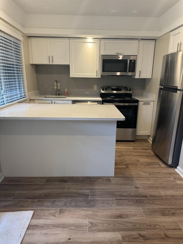 1231 Chamberlain Dr Unit 1231, Memphis, TN 38119 - kitchen with light countertops, a sink, white cabinets, and stainless steel appliances