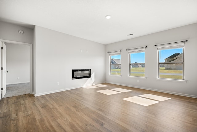 unfurnished living room with light hardwood / wood-style floors