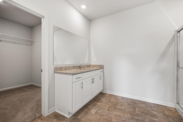 bathroom with vanity and walk in shower