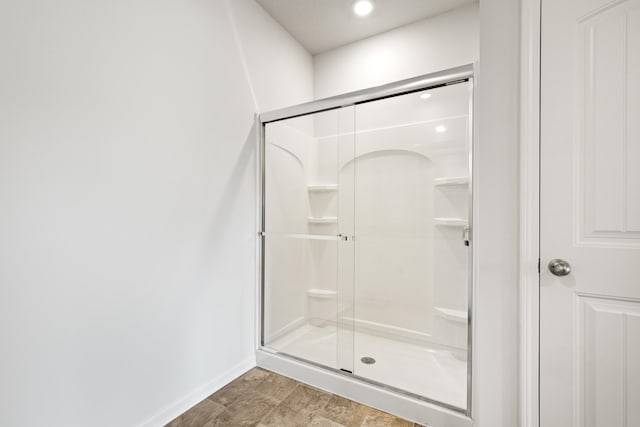 bathroom featuring a shower with shower door