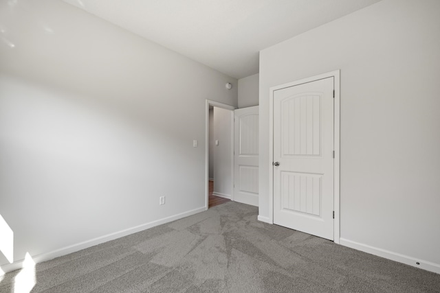 unfurnished bedroom featuring carpet and a closet