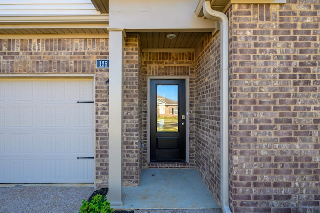 doorway to property with a garage