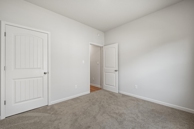 unfurnished bedroom featuring carpet floors and a closet