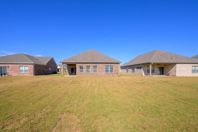 rear view of property with a patio and a yard