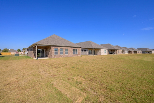 rear view of property with a yard