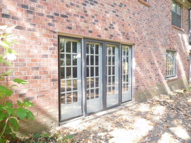 view of exterior entry featuring french doors