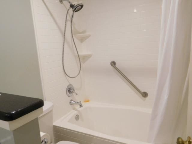 bathroom featuring toilet and shower / bathtub combination with curtain