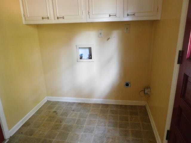 clothes washing area with washer hookup, hookup for an electric dryer, and cabinets