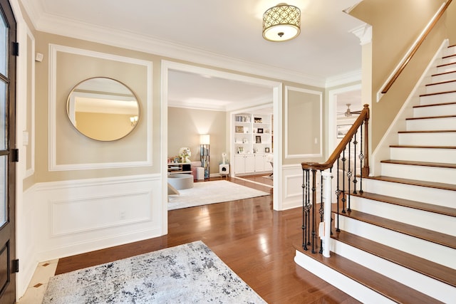 entryway featuring ornamental molding and dark hardwood / wood-style flooring