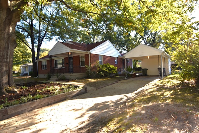 view of front facade with covered porch and a carport