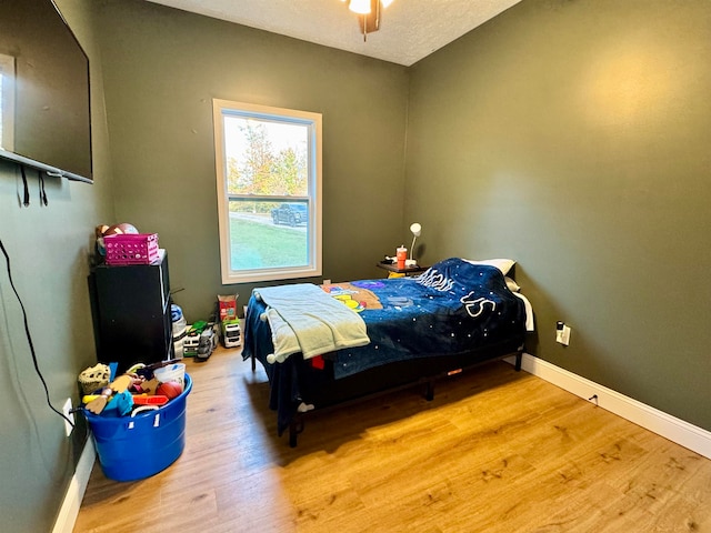 bedroom featuring hardwood / wood-style flooring and ceiling fan