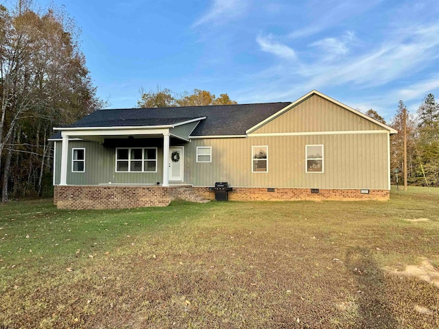 rear view of property with a lawn