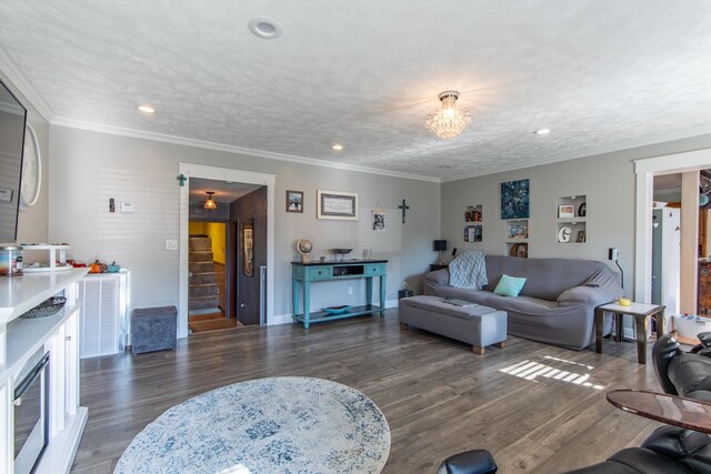 living room with ornamental molding, a textured ceiling, and dark hardwood / wood-style flooring