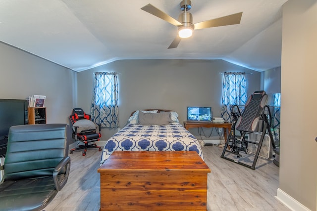 bedroom with vaulted ceiling, light hardwood / wood-style flooring, and ceiling fan