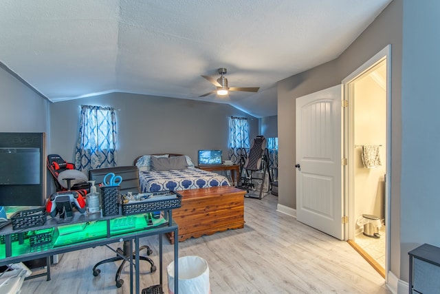 bedroom with light hardwood / wood-style floors, a textured ceiling, vaulted ceiling, and ceiling fan