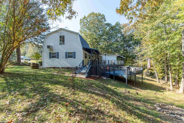 back of house with a wooden deck and a yard