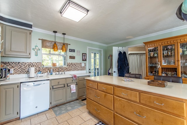 kitchen featuring sink, backsplash, white dishwasher, crown molding, and light tile patterned floors