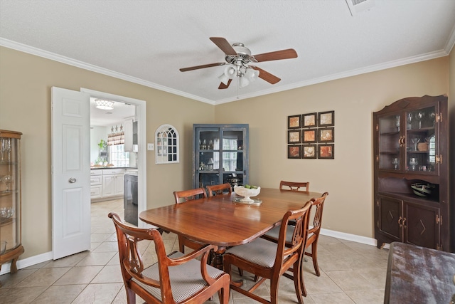 dining area with crown molding, a textured ceiling, light tile patterned floors, and ceiling fan