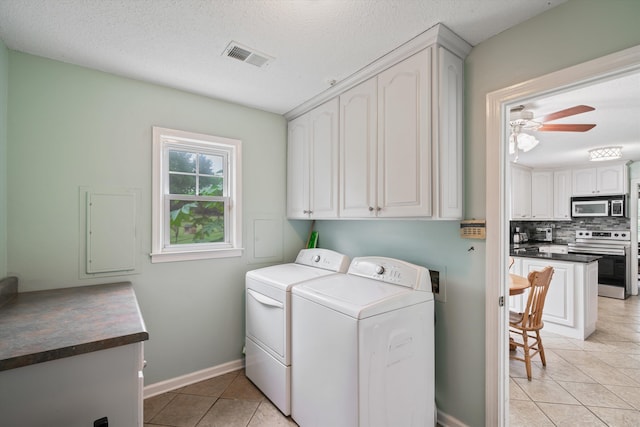 washroom with washer and clothes dryer, light tile patterned flooring, cabinets, a textured ceiling, and ceiling fan