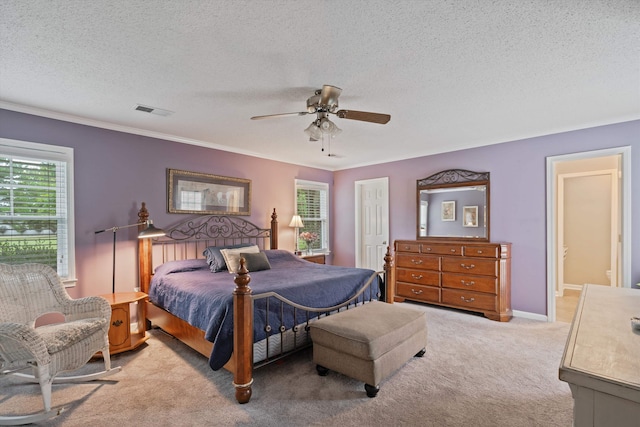 carpeted bedroom featuring crown molding, a textured ceiling, and ceiling fan