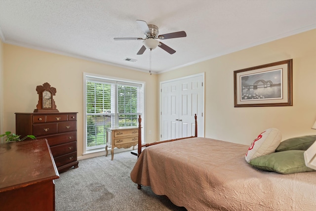 bedroom featuring ornamental molding, a textured ceiling, carpet flooring, and ceiling fan