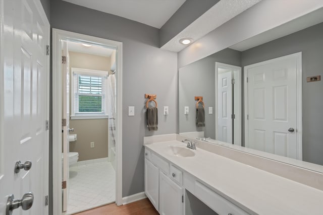 bathroom featuring vanity, toilet, curtained shower, and tile patterned flooring