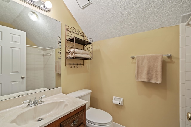 bathroom with tiled shower, toilet, vaulted ceiling, vanity, and a textured ceiling