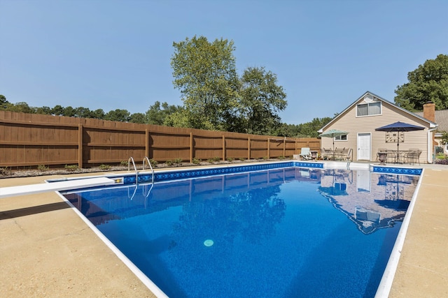 view of pool featuring a diving board