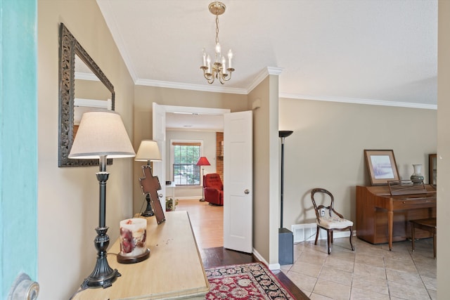 entryway with light hardwood / wood-style floors, a notable chandelier, and ornamental molding