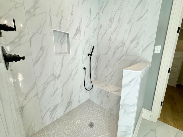 bathroom with tiled shower