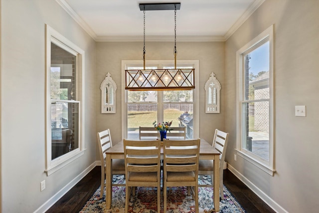 dining area with dark wood-type flooring, crown molding, and plenty of natural light