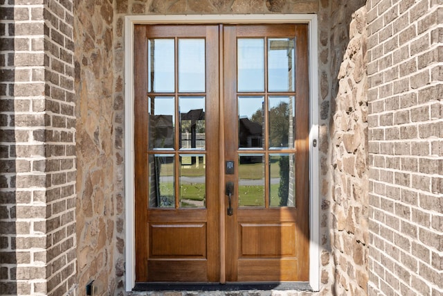 view of exterior entry featuring french doors