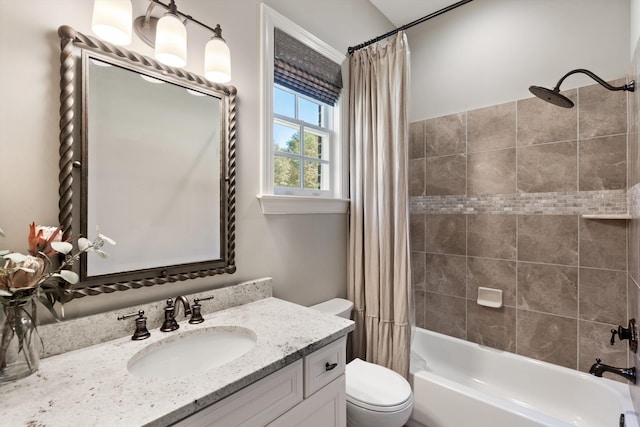 full bathroom featuring vanity, shower / bath combo with shower curtain, and toilet