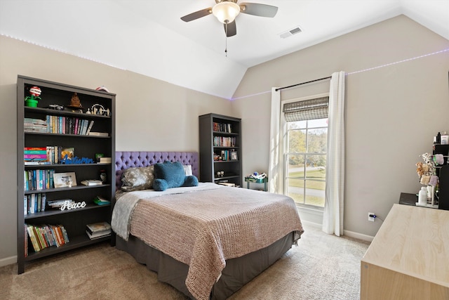 carpeted bedroom with ceiling fan and vaulted ceiling