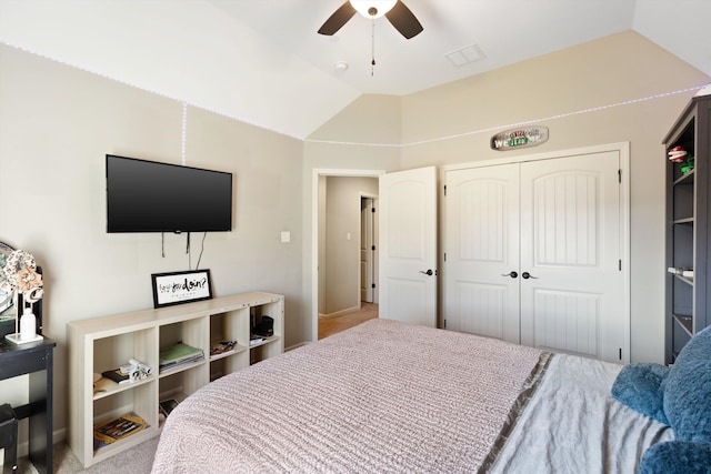 carpeted bedroom featuring a closet, ceiling fan, and vaulted ceiling