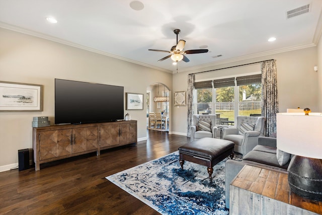 living room featuring crown molding, ceiling fan, and dark hardwood / wood-style flooring